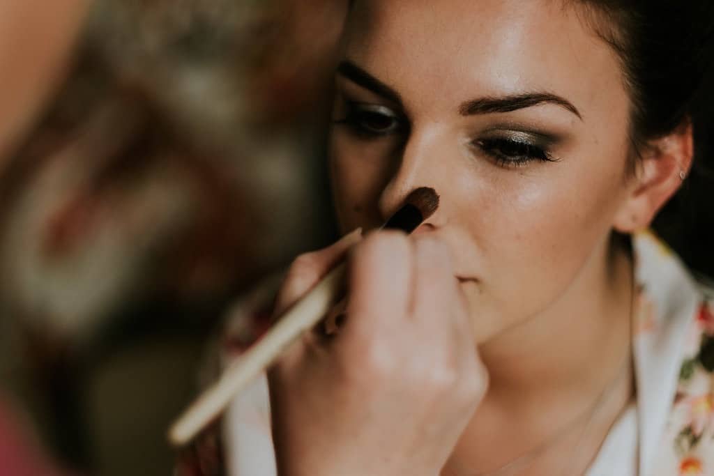 make up being put on woman by professional