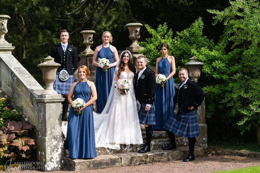 newly wedded Scottish couple with bridesmaids and groomsmen