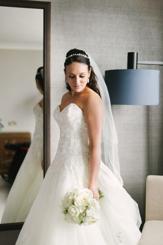 bride taking picture in hotel room