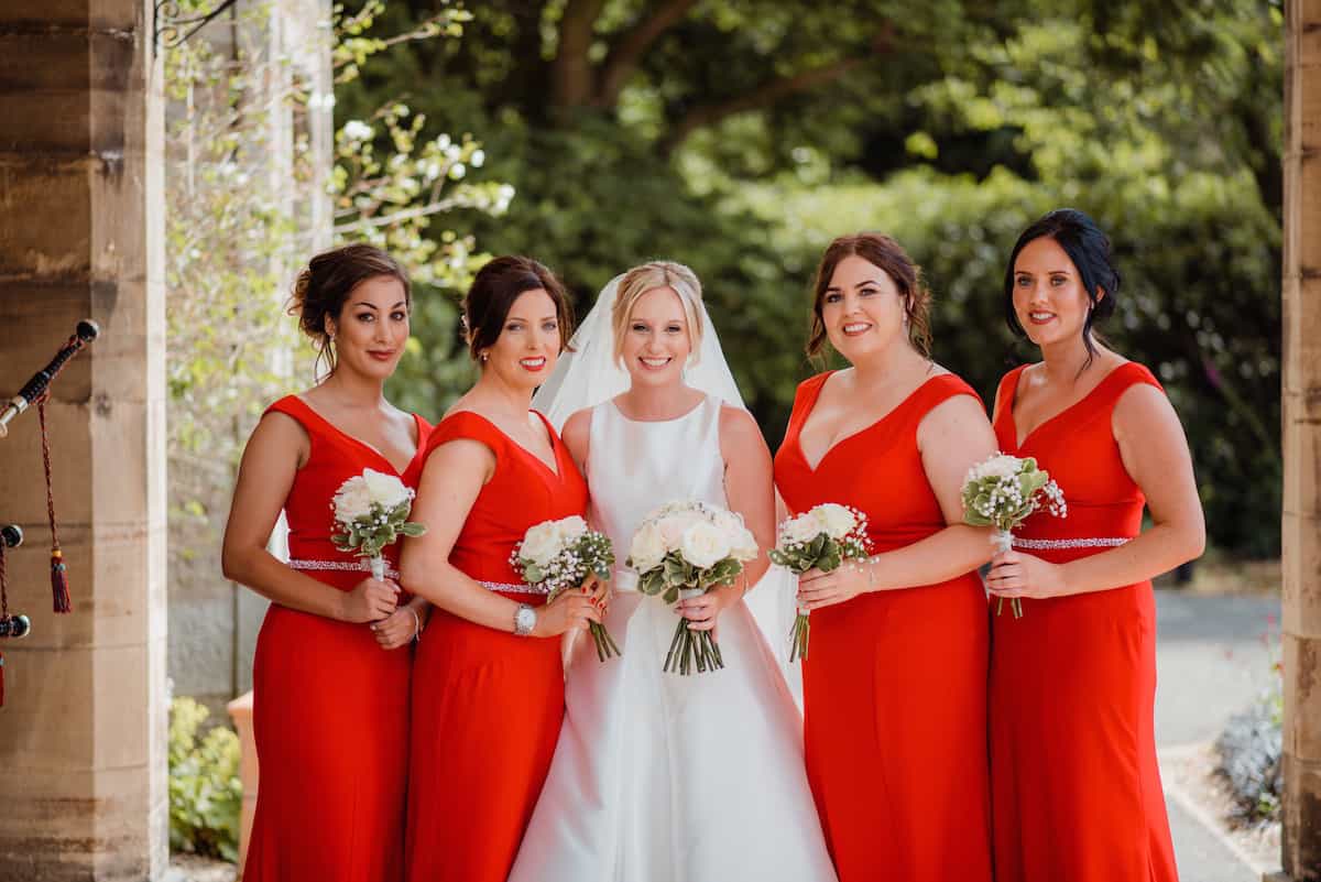 bride taking picture with bridesmaids before wedding