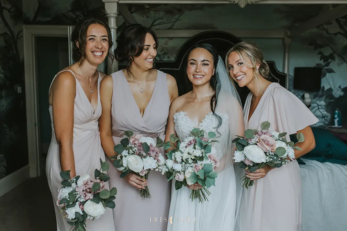 bride with three bridesmaids holding bouquets of flowers