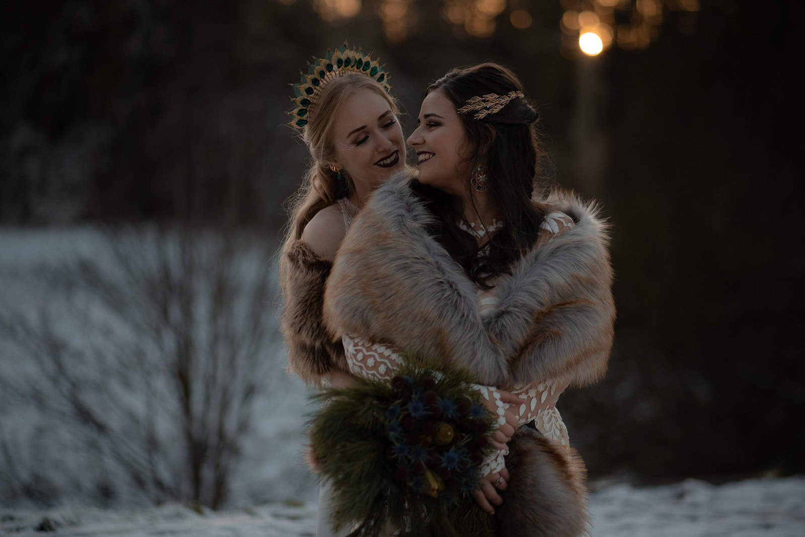 two women hugging each other in winter background